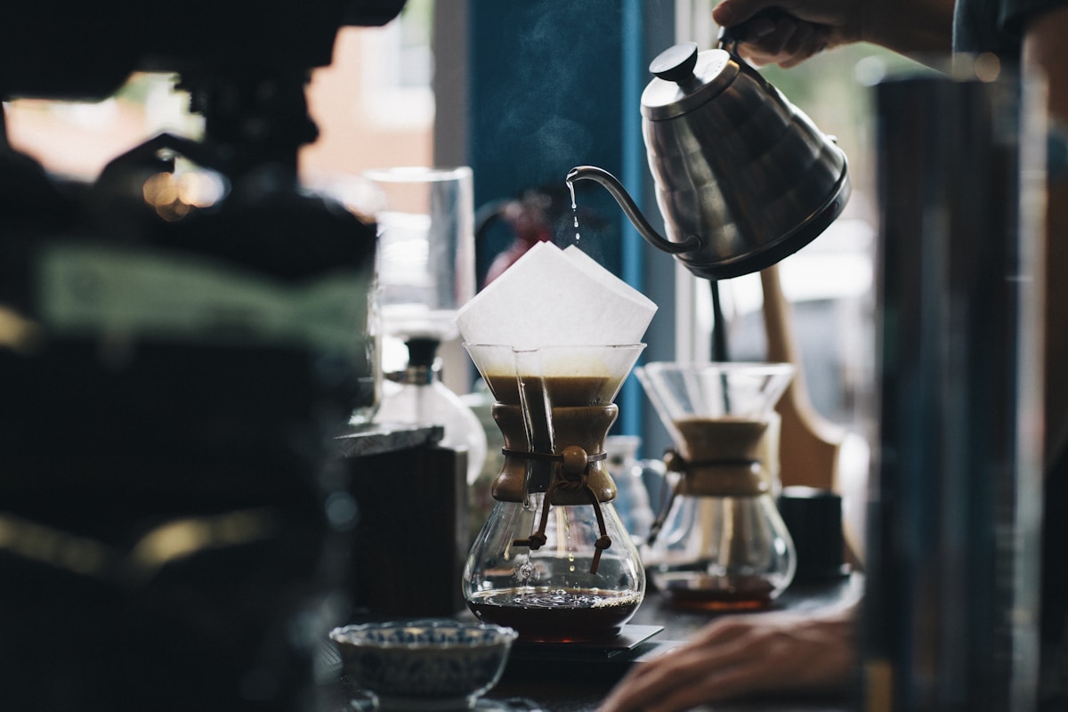 Barista completing a precise milk pour for latte art