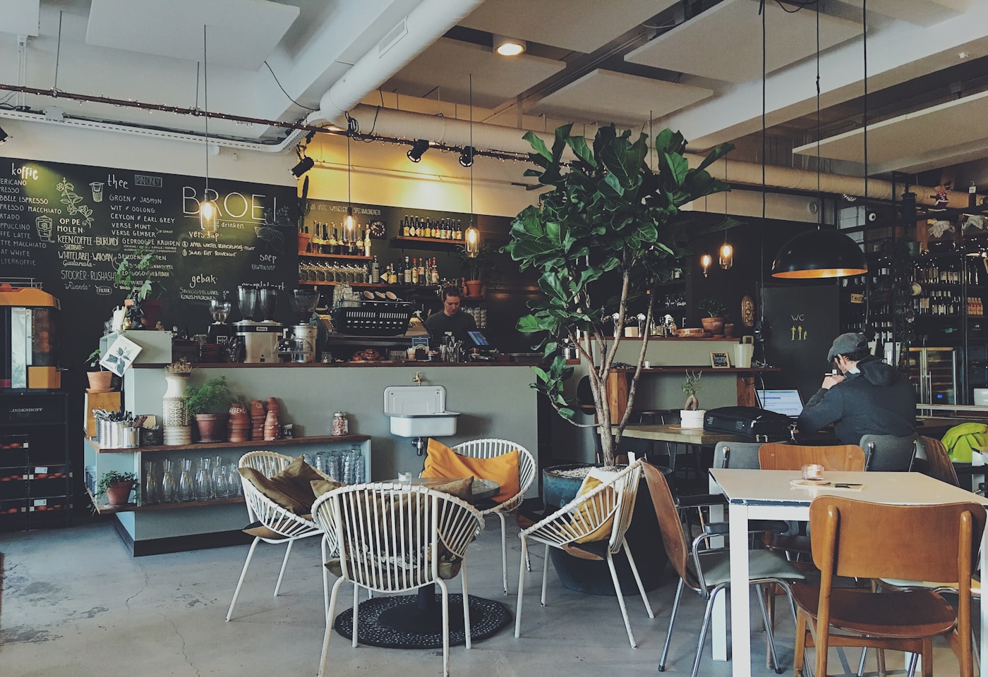 Sunlit interior of the BrewSpark salon with wooden tables and soft morning atmosphere